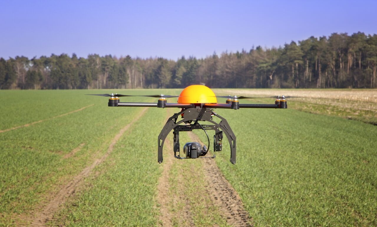 Flying drone in the field - Robert Mandel via Shutterstock